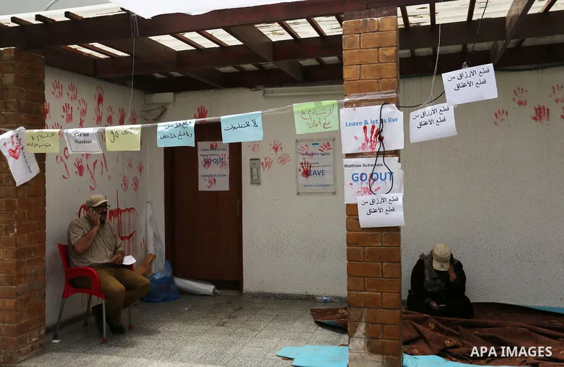 Palestinian employees of United Nations Relief and Works Agency (UNRWA) take part in a protest against jobs termination by UNRWA outside its headquarters in Gaza City, on July 25, 2018. Photo by Ashraf Amra