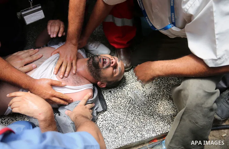 An employee of United Nations Relief and Works Agency (UNRWA) faints during a protest against jobs termination by UNRWA inside its headquarters in Gaza City, on July 25, 2018. Photo by Ashraf Amra