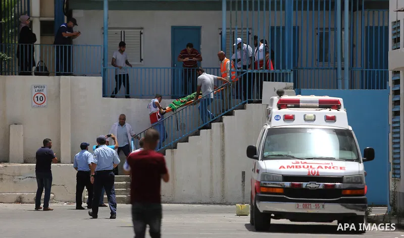 An employee of United Nations Relief and Works Agency (UNRWA) faints during a protest against jobs termination by UNRWA inside its headquarters in Gaza City, on July 25, 2018. Photo by Ashraf Amra