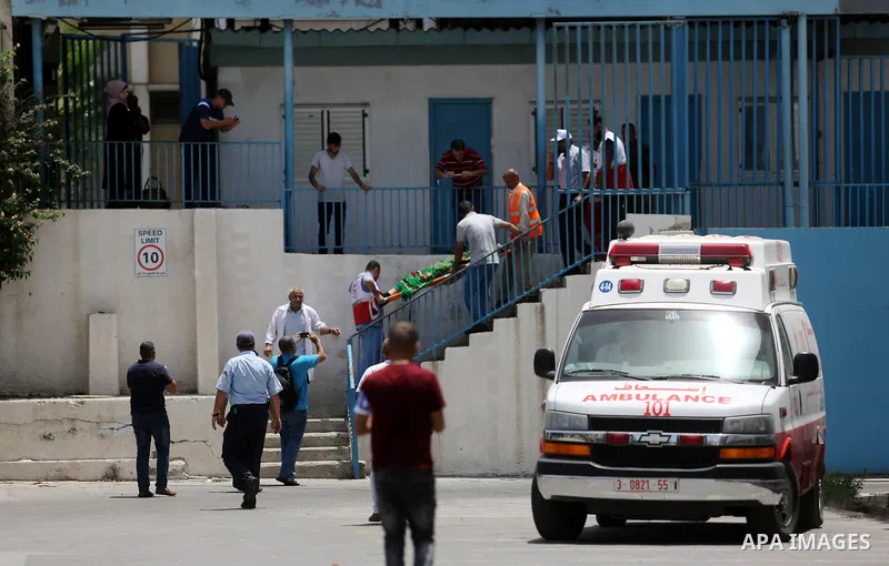 An employee of United Nations Relief and Works Agency (UNRWA) faints during a protest against jobs termination by UNRWA inside its headquarters in Gaza City, on July 25, 2018. Photo by Ashraf Amra