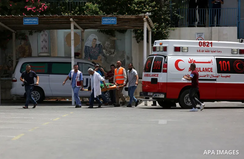 An employee of United Nations Relief and Works Agency (UNRWA) faints during a protest against jobs termination by UNRWA inside its headquarters in Gaza City, on July 25, 2018. Photo by Ashraf Amra