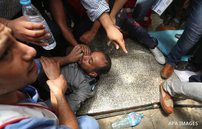 An employee of United Nations Relief and Works Agency (UNRWA) faints during a protest against jobs termination by UNRWA inside its headquarters in Gaza City, on July 25, 2018. Photo by Ashraf Amra