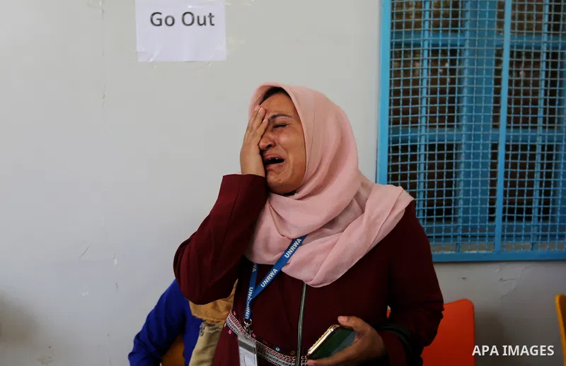 An employee of United Nations Relief and Works Agency (UNRWA) reacts during a protest against jobs termination by UNRWA inside its headquarters in Gaza City, on July 25, 2018. Photo by Ashraf Amra