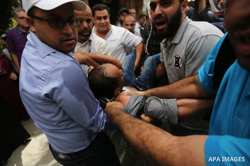 An employee of United Nations Relief and Works Agency (UNRWA) faints during a protest against jobs termination by UNRWA inside its headquarters in Gaza City, on July 25, 2018. Photo by Ashraf Amra