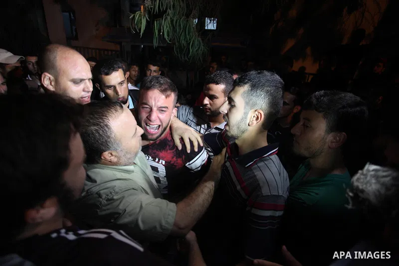 Palestinian relatives of Hamas members, who were killed by Israeli bombardment near the border with Israel, mourn outside al-shifa hospital in Gaza city on July 25, 2018. Photo by Mahmoud Ajour