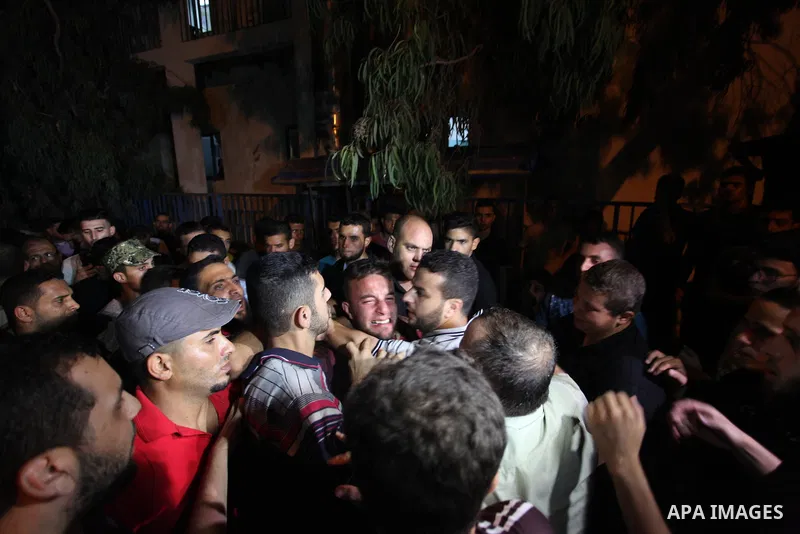 Palestinian relatives of Hamas members, who were killed by Israeli bombardment near the border with Israel, mourn outside al-shifa hospital in Gaza city on July 25, 2018. Photo by Mahmoud Ajour