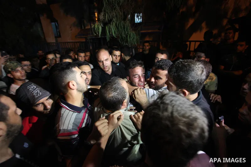 Palestinian relatives of Hamas members, who were killed by Israeli bombardment near the border with Israel, mourn outside al-shifa hospital in Gaza city on July 25, 2018. Photo by Mahmoud Ajour