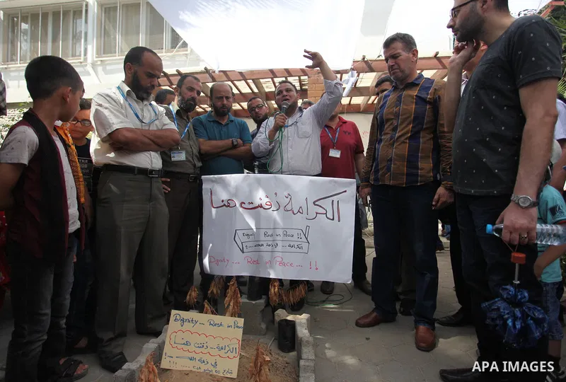 Palestinian employees of United Nations Relief and Works Agency (UNRWA) take part in a protest against jobs termination by UNRWA inside its headquarters in Gaza City, on July 26, 2018. Photo by Mahmoud Ajour