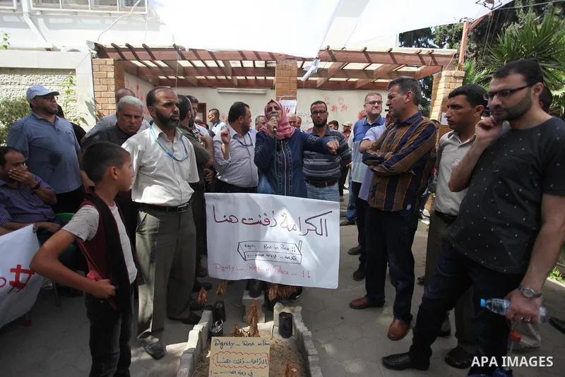 Palestinian employees of United Nations Relief and Works Agency (UNRWA) take part in a protest against jobs termination by UNRWA inside its headquarters in Gaza City, on July 26, 2018. Photo by Mahmoud Ajour