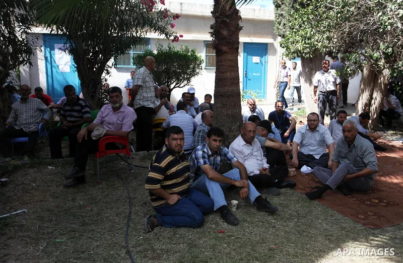 Palestinian employees of United Nations Relief and Works Agency (UNRWA) take part in a protest against jobs termination by UNRWA inside its headquarters in Gaza City, on July 26, 2018. Photo by Mahmoud Ajour