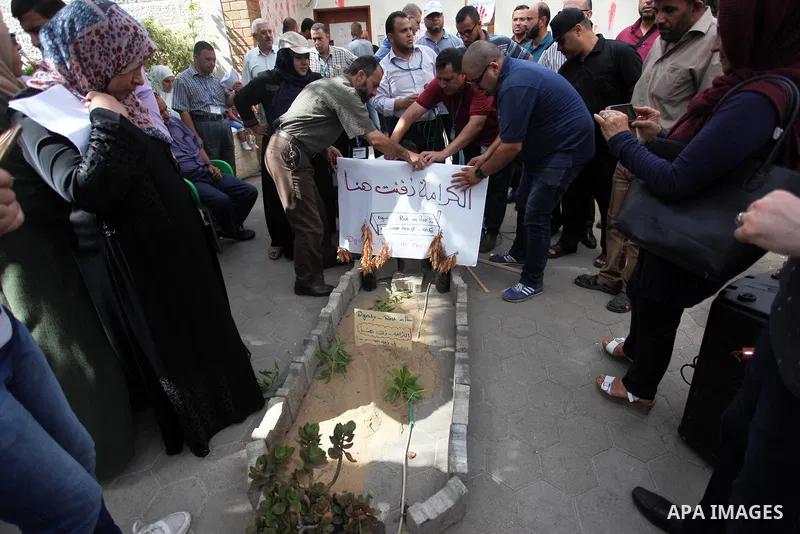 Palestinian employees of United Nations Relief and Works Agency (UNRWA) take part in a protest against jobs termination by UNRWA inside its headquarters in Gaza City, on July 26, 2018. Photo by Mahmoud Ajour