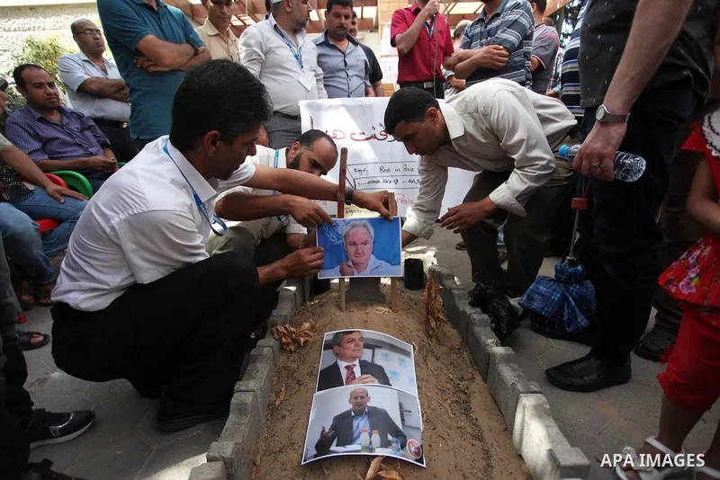 Palestinian employees of United Nations Relief and Works Agency (UNRWA) take part in a protest against jobs termination by UNRWA inside its headquarters in Gaza City, on July 26, 2018. Photo by Mahmoud Ajour