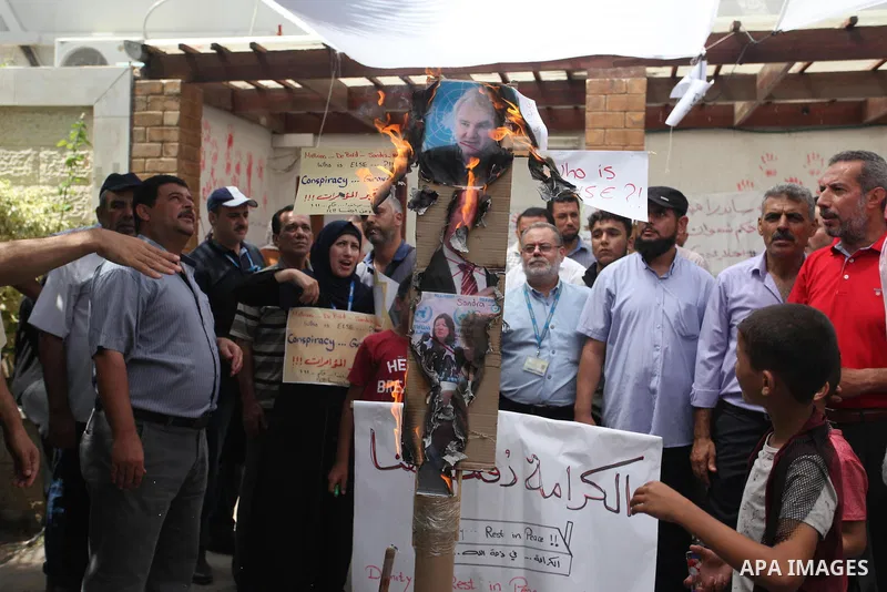 Palestinian employees of United Nations Relief and Works Agency (UNRWA) take part in a protest against jobs termination by UNRWA inside its headquarters in Gaza City, on July 26, 2018. Photo by Mahmoud Ajour
