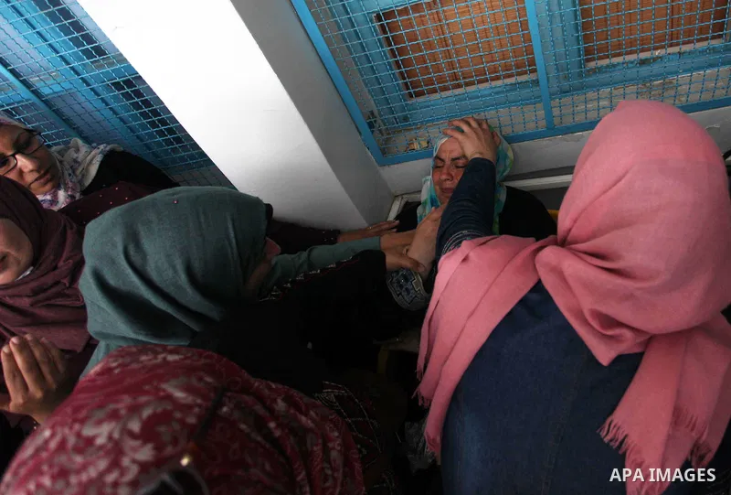 Palestinian employees of United Nations Relief and Works Agency (UNRWA) take part in a protest against jobs termination by UNRWA inside its headquarters in Gaza City, on July 26, 2018. Photo by Mahmoud Ajour
