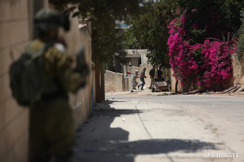 Israeli security forces take position during clashes with Palestinian protesters following a demonstration against the expropriation of Palestinian land by Israel in the village of Kfar Qaddum, near Nablus, in the occupi...