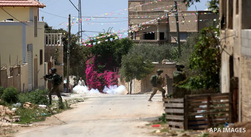 Israeli security forces take position during clashes with Palestinian protesters following a demonstration against the expropriation of Palestinian land by Israel in the village of Kfar Qaddum, near Nablus, in the occupi...