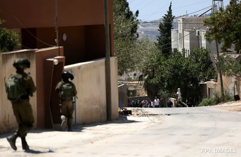 Israeli security forces take position during clashes with Palestinian protesters following a demonstration against the expropriation of Palestinian land by Israel in the village of Kfar Qaddum, near Nablus, in the occupi...