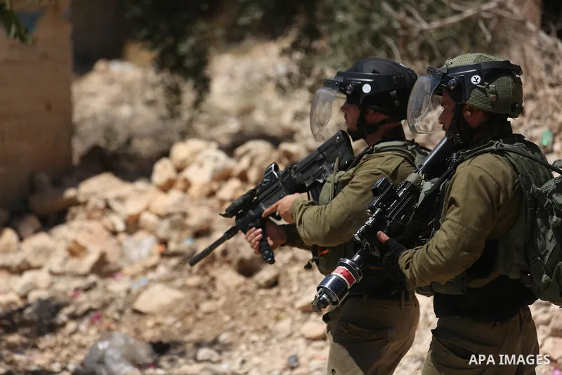 Israeli security forces take position during clashes with Palestinian protesters following a demonstration against the expropriation of Palestinian land by Israel in the village of Kfar Qaddum, near Nablus, in the occupi...