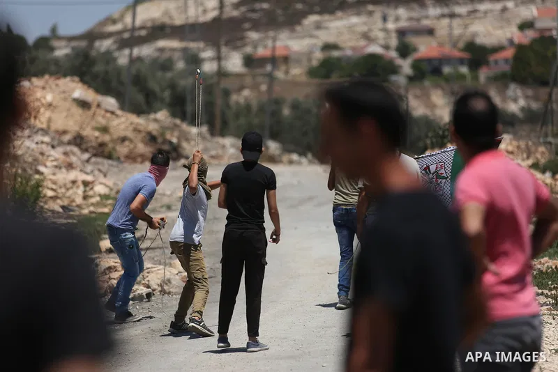 Palestinian protesters gather during clashes with Israeli troops following a demonstration against the expropriation of Palestinian land by Israel in the village of Kfar Qaddum, near Nablus, in the occupied West Bank on...