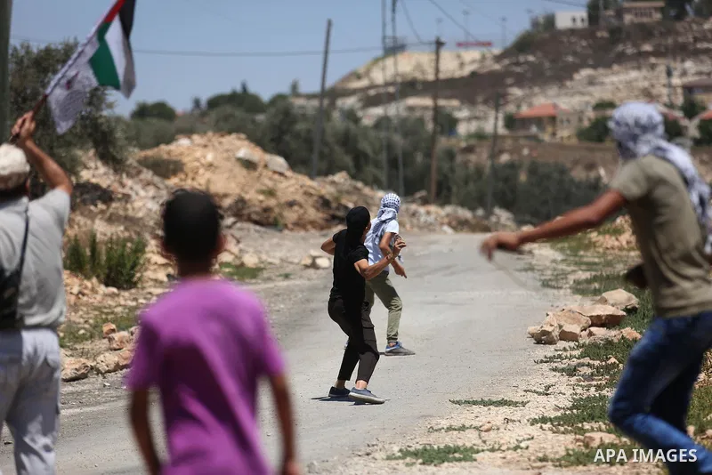 Palestinian protesters gather during clashes with Israeli troops following a demonstration against the expropriation of Palestinian land by Israel in the village of Kfar Qaddum, near Nablus, in the occupied West Bank on...