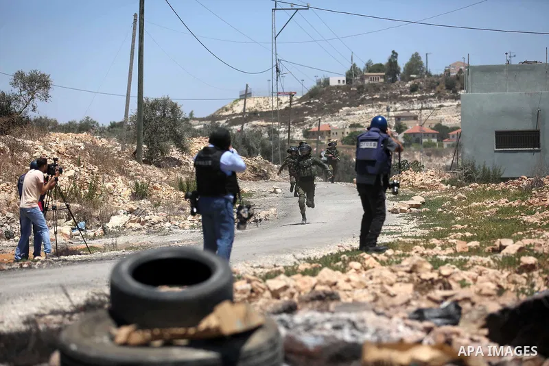 Palestinian protesters gather during clashes with Israeli troops following a demonstration against the expropriation of Palestinian land by Israel in the village of Kfar Qaddum, near Nablus, in the occupied West Bank on...