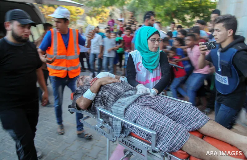 A Palestinian who was wounded during clashes with Israeli troops at Gaza-Israel border is carried on stretcher outside a hospital, in Jabalia in the northern of Gaza Strip on July 27, 2018. Photo by Ramez Habboub