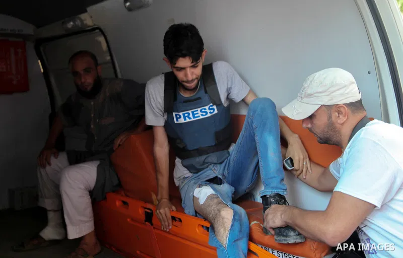 A Palestinian who was wounded during clashes with Israeli troops at Gaza-Israel border is carried on stretcher outside a hospital, in Jabalia in the northern of Gaza Strip on July 27, 2018. Photo by Ramez Habboub