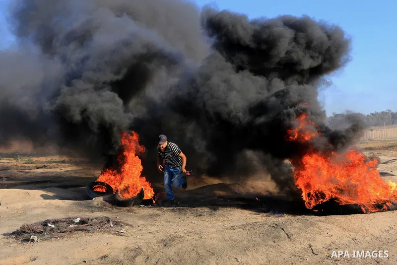 Palestinian protesters gather during clashes with Israeli troops in tents protest where Palestinian demand the right to return to their homeland at the Israel-Gaza border, in al-Bureij in the center of Gaza Strip on July...