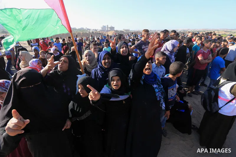 Palestinian protesters gather during clashes with Israeli troops in tents protest where Palestinian demand the right to return to their homeland at the Israel-Gaza border, in al-Bureij in the center of Gaza Strip on July...