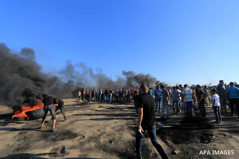 Palestinian protesters gather during clashes with Israeli troops in tents protest where Palestinian demand the right to return to their homeland at the Israel-Gaza border, in al-Bureij in the center of Gaza Strip on July...