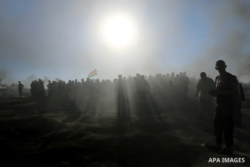 Palestinian protesters gather during clashes with Israeli troops in tents protest where Palestinian demand the right to return to their homeland at the Israel-Gaza border, in al-Bureij in the center of Gaza Strip on July...