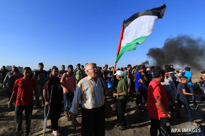 Palestinian protesters gather during clashes with Israeli troops in tents protest where Palestinian demand the right to return to their homeland at the Israel-Gaza border, in al-Bureij in the center of Gaza Strip on July...