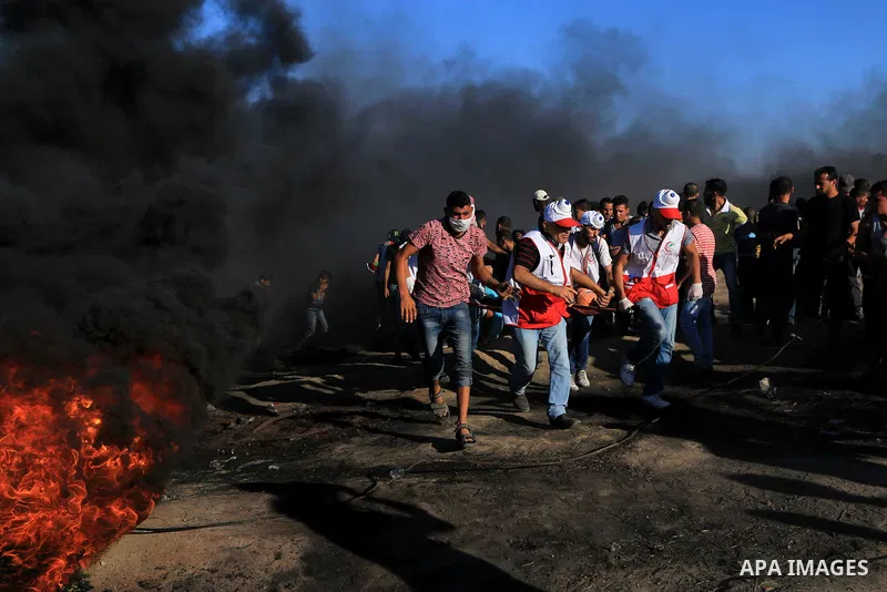 Palestinian protesters gather during clashes with Israeli troops in tents protest where Palestinian demand the right to return to their homeland at the Israel-Gaza border, in al-Bureij in the center of Gaza Strip on July...