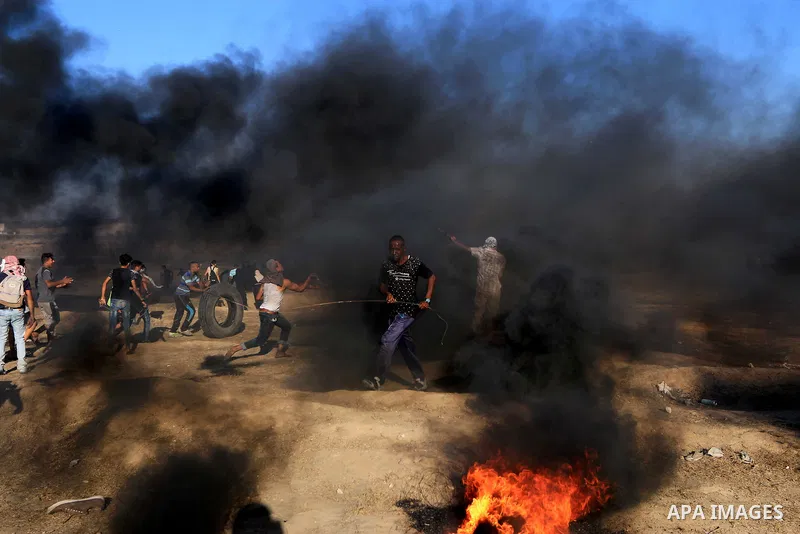 Palestinian protesters gather during clashes with Israeli troops in tents protest where Palestinian demand the right to return to their homeland at the Israel-Gaza border, in al-Bureij in the center of Gaza Strip on July...