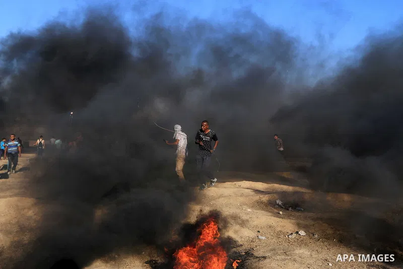 Palestinian protesters gather during clashes with Israeli troops in tents protest where Palestinian demand the right to return to their homeland at the Israel-Gaza border, in al-Bureij in the center of Gaza Strip on July...