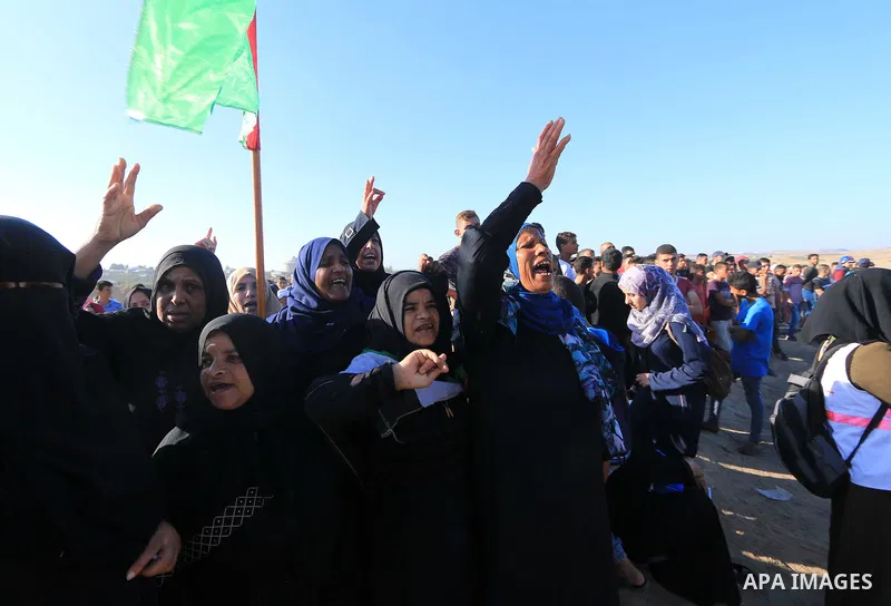 Palestinian protesters gather during clashes with Israeli troops in tents protest where Palestinian demand the right to return to their homeland at the Israel-Gaza border, in al-Bureij in the center of Gaza Strip on July...