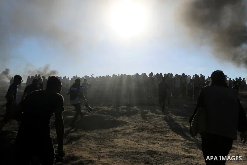 Palestinian protesters gather during clashes with Israeli troops in tents protest where Palestinian demand the right to return to their homeland at the Israel-Gaza border, in al-Bureij in the center of Gaza Strip on July...