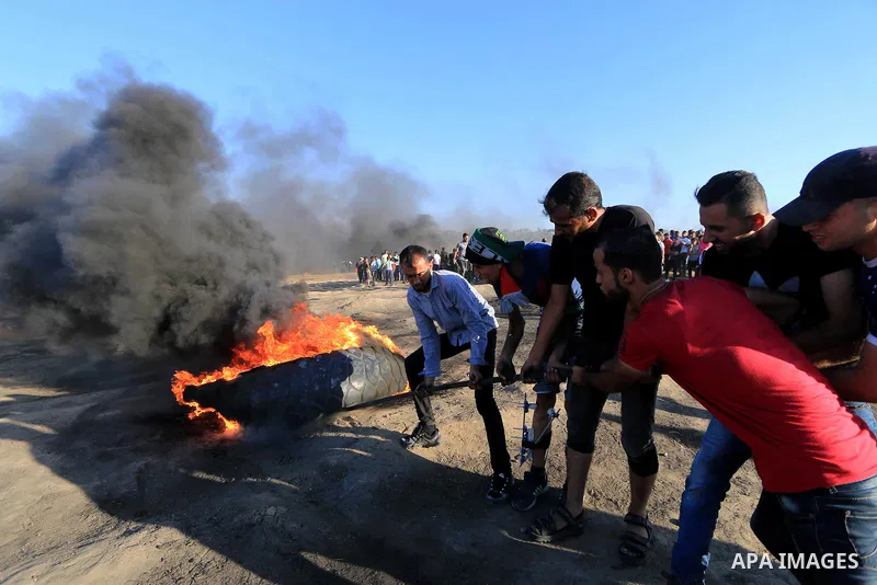 Palestinian protesters gather during clashes with Israeli troops in tents protest where Palestinian demand the right to return to their homeland at the Israel-Gaza border, in al-Bureij in the center of Gaza Strip on July...