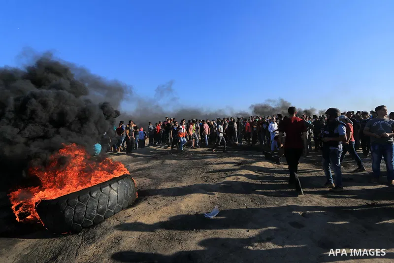 Palestinian protesters gather during clashes with Israeli troops in tents protest where Palestinian demand the right to return to their homeland at the Israel-Gaza border, in al-Bureij in the center of Gaza Strip on July...