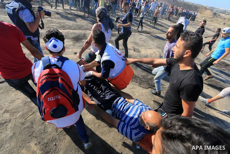 Palestinian protesters gather during clashes with Israeli troops in tents protest where Palestinian demand the right to return to their homeland at the Israel-Gaza border, in al-Bureij in the center of Gaza Strip on July...