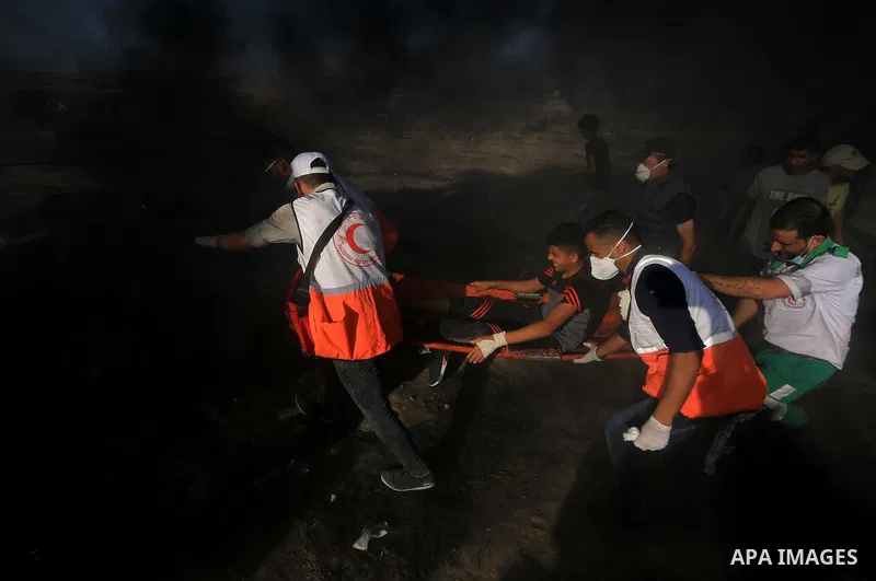 Palestinian protesters gather during clashes with Israeli troops in tents protest where Palestinian demand the right to return to their homeland at the Israel-Gaza border, in al-Bureij in the center of Gaza Strip on July...