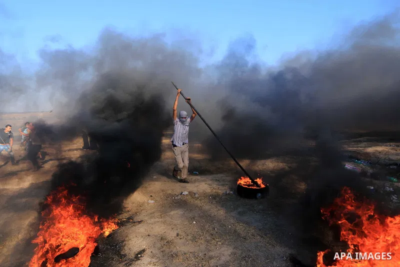 Palestinian protesters gather during clashes with Israeli troops in tents protest where Palestinian demand the right to return to their homeland at the Israel-Gaza border, in al-Bureij in the center of Gaza Strip on July...