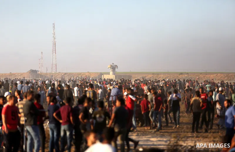 Palestinian protesters gather during clashes with Israeli troops in tents protest where Palestinian demand the right to return to their homeland at the Israel-Gaza border, in Khan Younis, in the southern Gaza Strip on Ju...