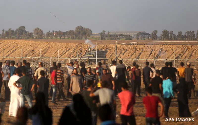 Palestinian protesters gather during clashes with Israeli troops in tents protest where Palestinian demand the right to return to their homeland at the Israel-Gaza border, in Khan Younis, in the southern Gaza Strip on Ju...