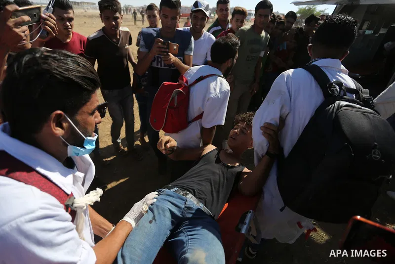 Injured Palestinian protestors receive treatment at a medical tent during clashes with Israeli security forces in tents protest where Palestinian demand the right to return to their homeland at the Israel-Gaza border, in...