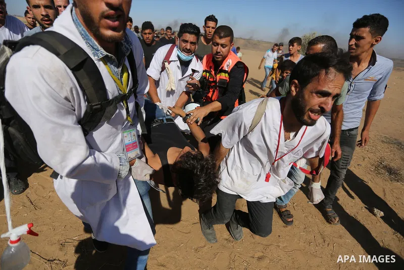 Injured Palestinian protestors receive treatment at a medical tent during clashes with Israeli security forces in tents protest where Palestinian demand the right to return to their homeland at the Israel-Gaza border, in...