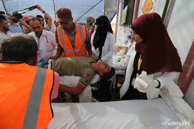 Injured Palestinian protestors receive treatment at a medical tent during clashes with Israeli security forces in tents protest where Palestinian demand the right to return to their homeland at the Israel-Gaza border, in...