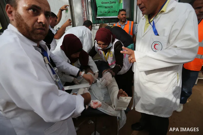 Injured Palestinian protestors receive treatment at a medical tent during clashes with Israeli security forces in tents protest where Palestinian demand the right to return to their homeland at the Israel-Gaza border, in...