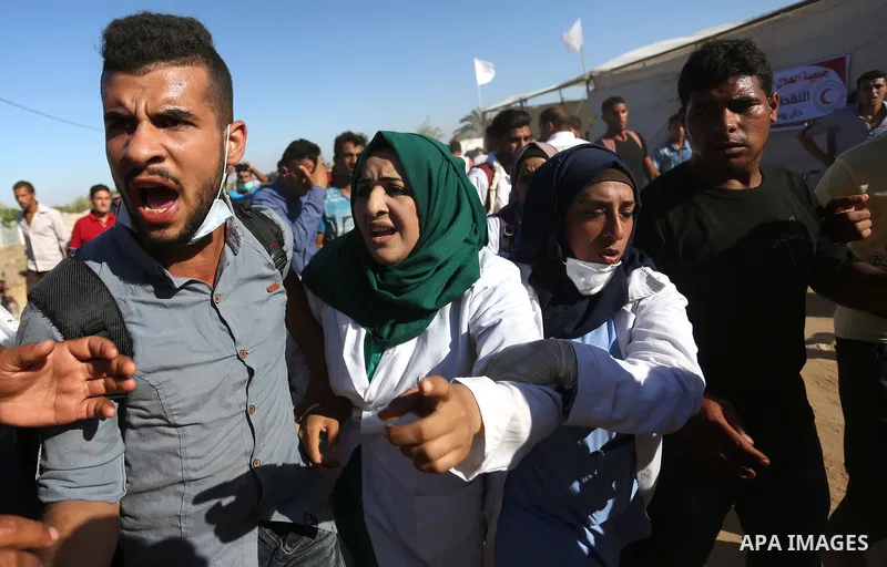 A Palestinian nurse reacts upon seeing the body of her husband who was killed by Israeli troops during clashes in tents protest where Palestinian demand the right to return to their homeland at the Israel-Gaza border, in...