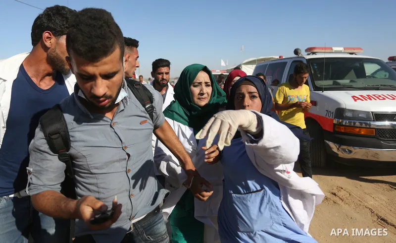 A Palestinian nurse reacts upon seeing the body of her husband who was killed by Israeli troops during clashes in tents protest where Palestinian demand the right to return to their homeland at the Israel-Gaza border, in...